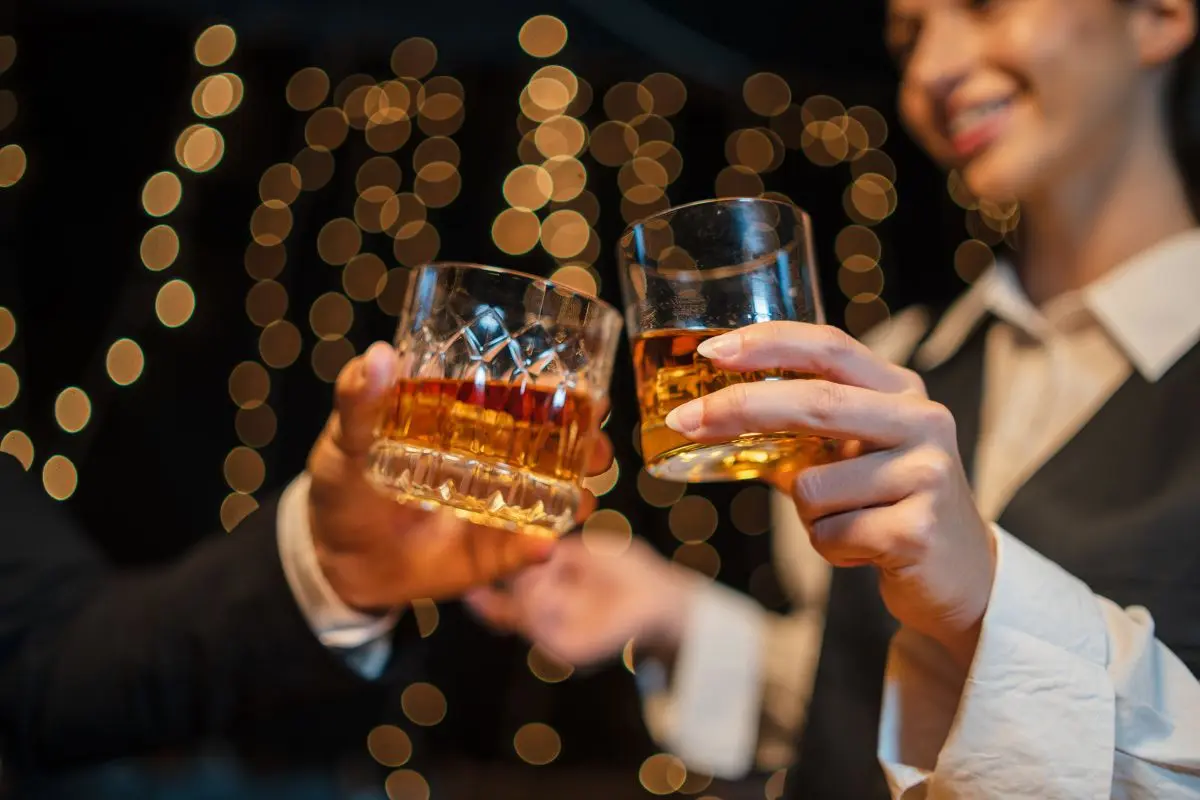 Two friends toasting glasses of whisky.