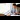 Food on Trains: A young businessman enjoys a sandwich while completing paperwork as he sits at a train window seat