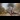 Rail Queens: Vintage steam locomotive with a bright headlamp and billowing black smoke travelling along railway tracks through an autumn landscape