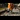 A railway worker digs into a track with a pitchfork