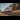 An old passenger train travels over rails during autumn