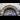 A photo of the arch above the entrance to Waterloo Station in London, and a clock showing the time as 2:20.