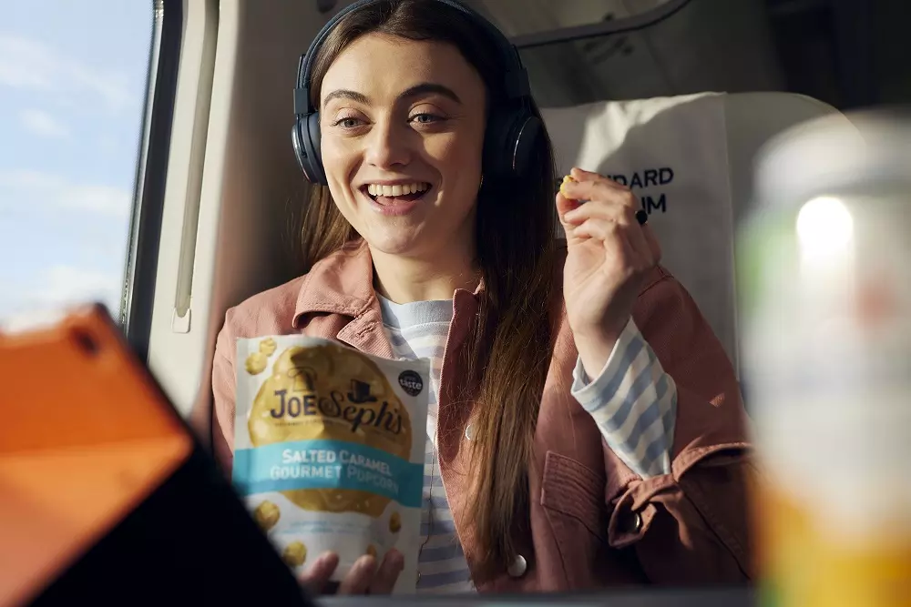 girl eating popcorn on train