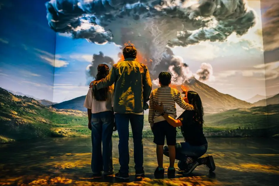 The back of a family looking at an exhibit at The Last Days of Pompeii Immersive Exhibition
