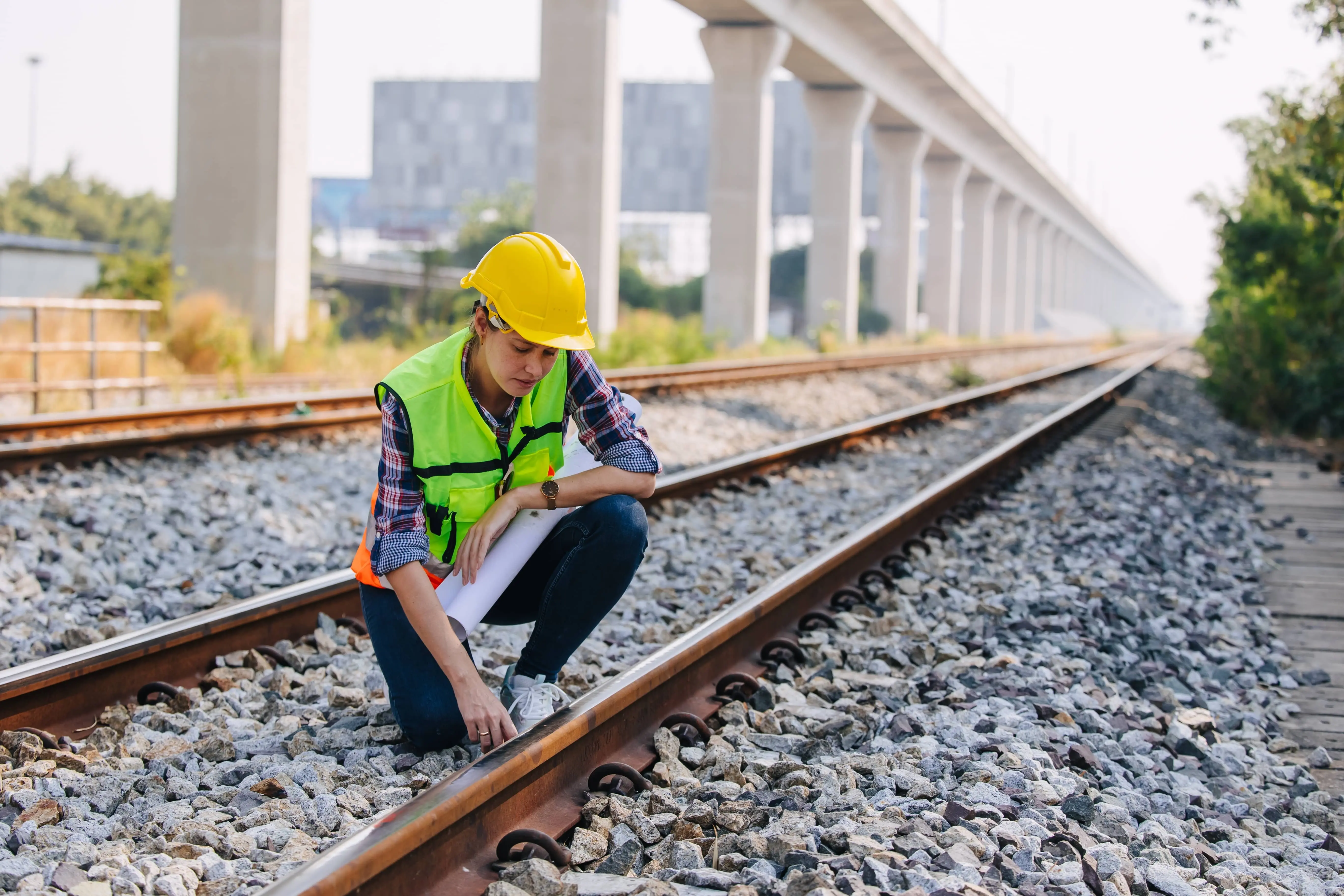 Famous Women in Rail: A female railway engineer inspects railway tracks.