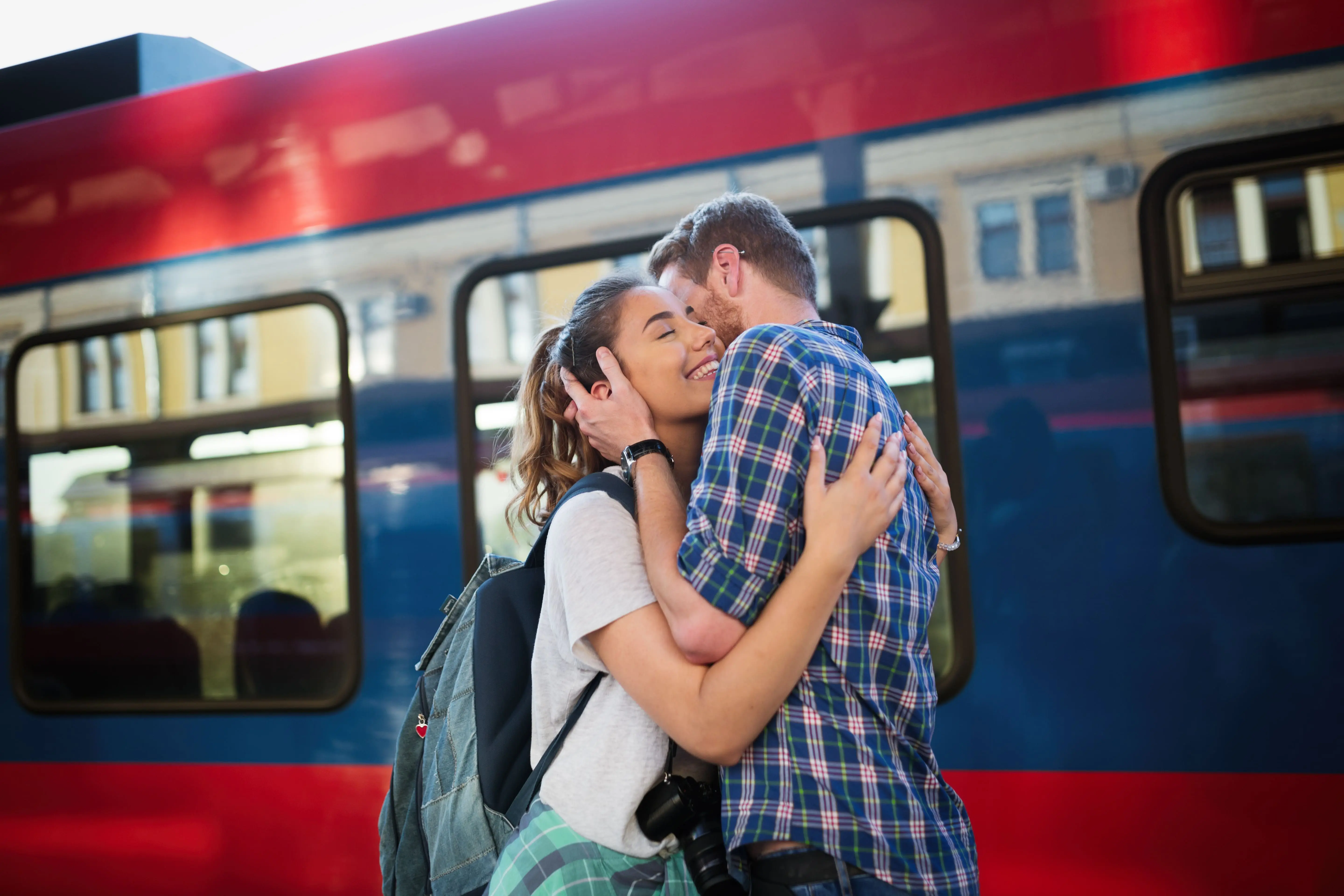 Community Rails: A young couple reuniting at a train station