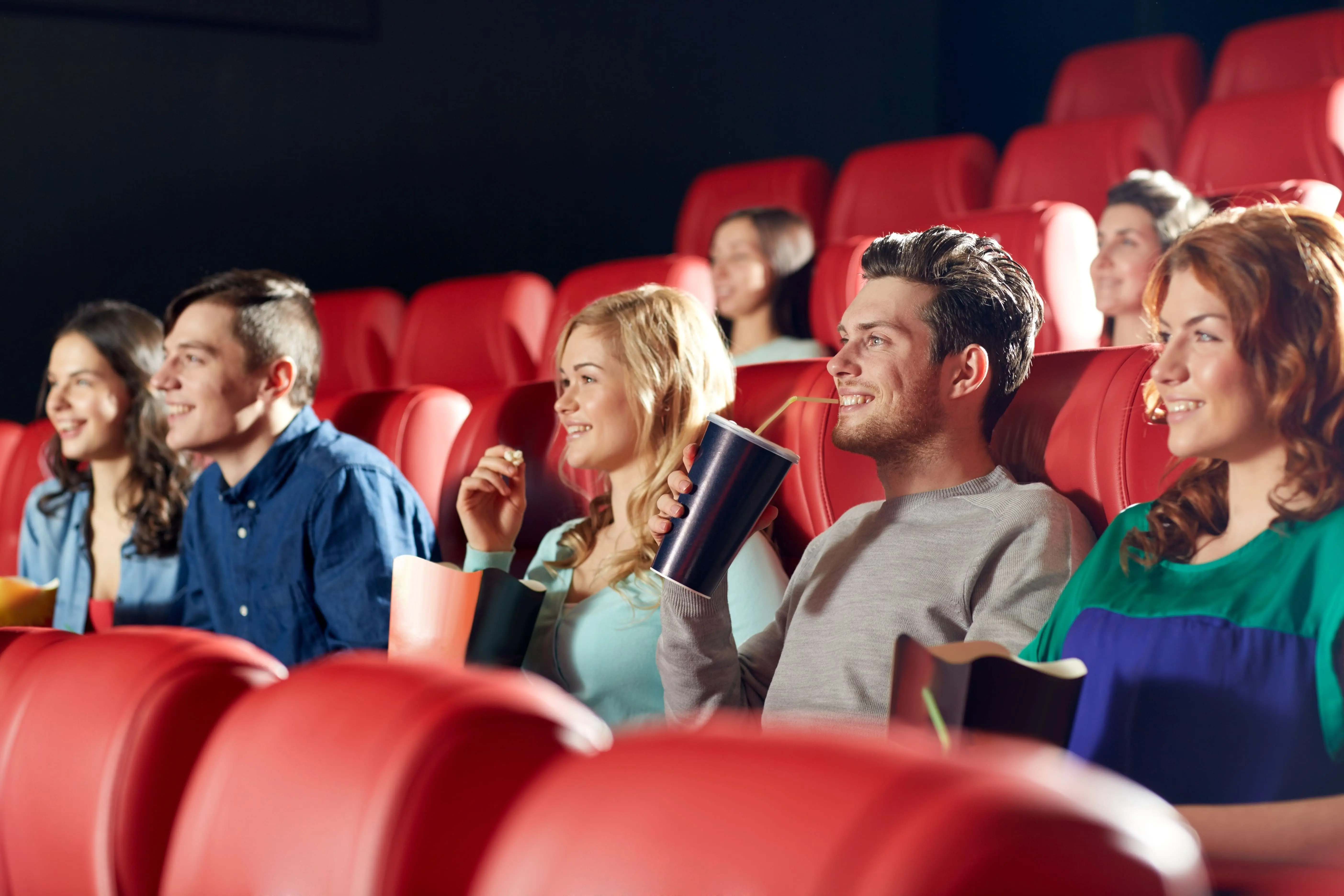 Train Movies: A group of friends watching a movie in a theatre