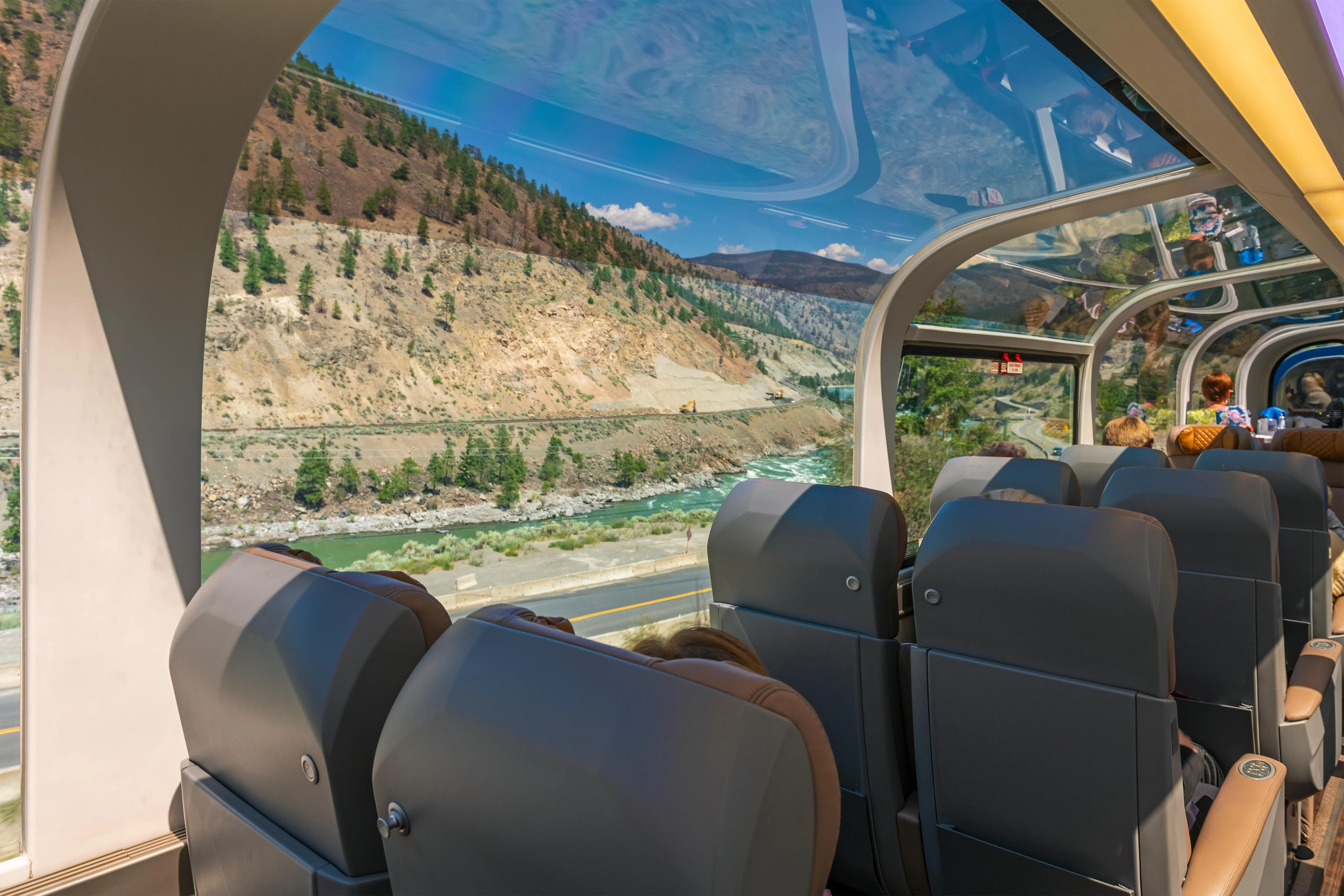 The World’s Most Iconic Trains: Passengers sitting inside one of Rocky Mountaineer’s 360-degree panoramic train carriage