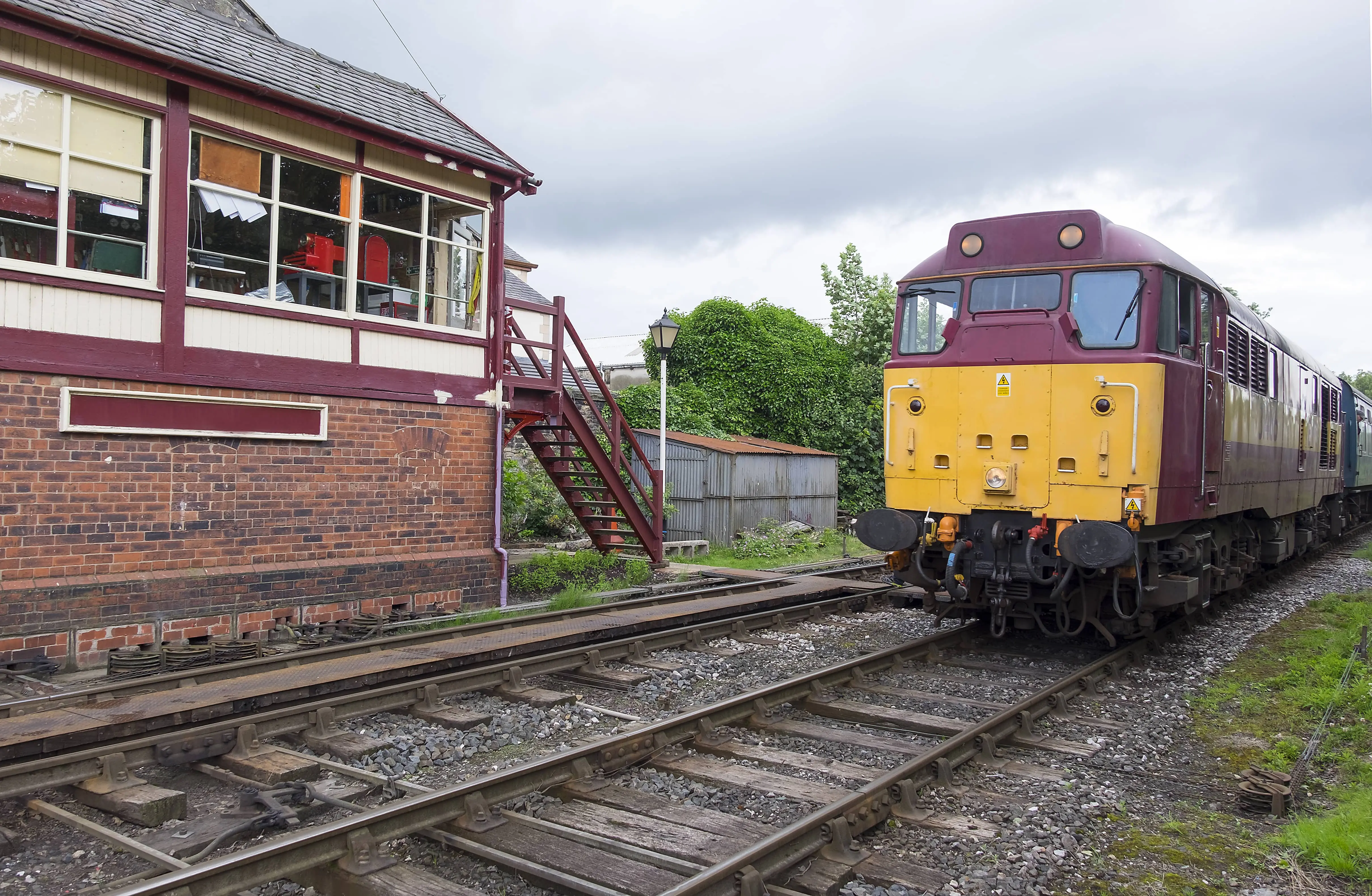 A heritage diesel unit approaching an old station