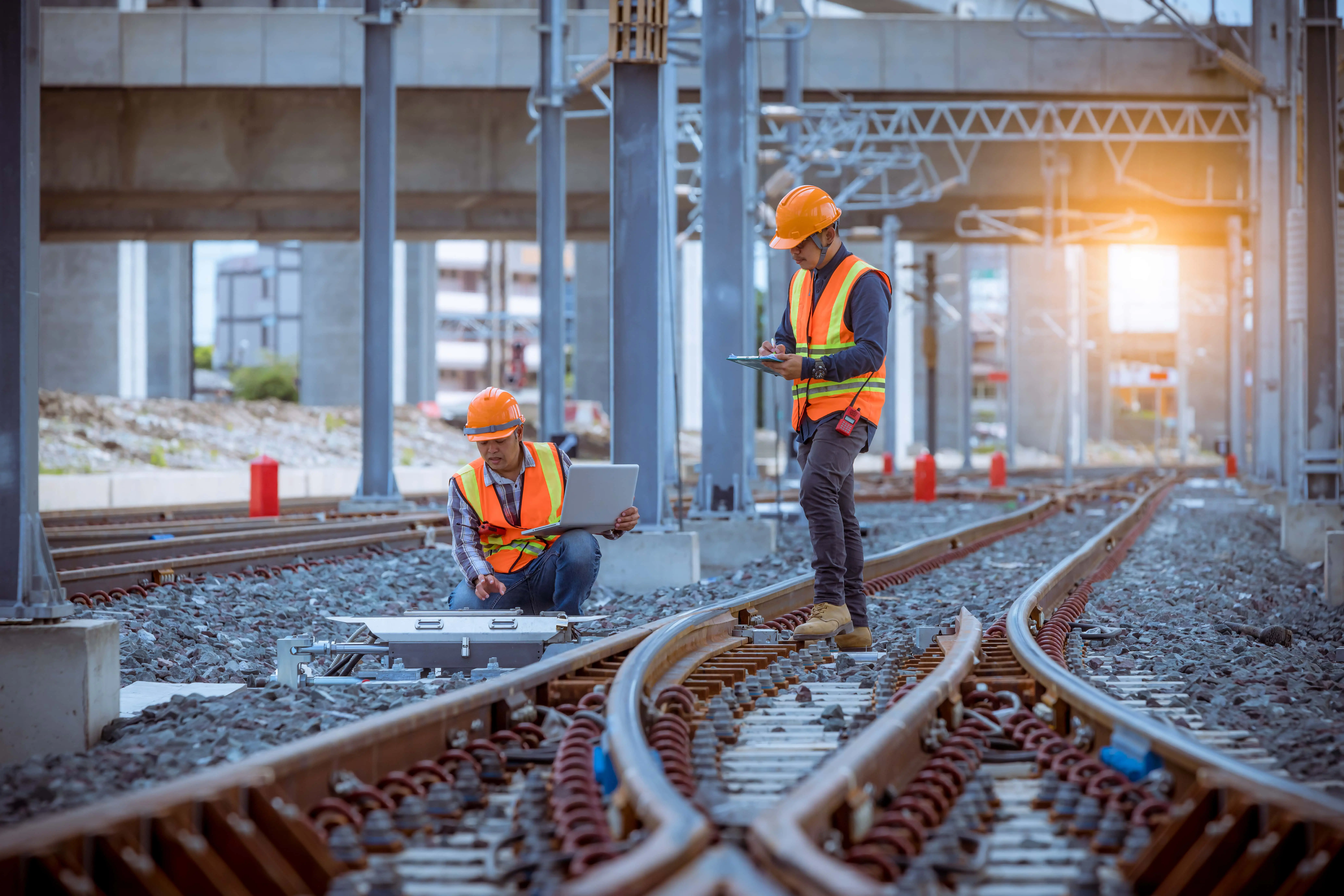 UK Locomotives: Electric: Two railway engineers in high viz inspect the railway line.