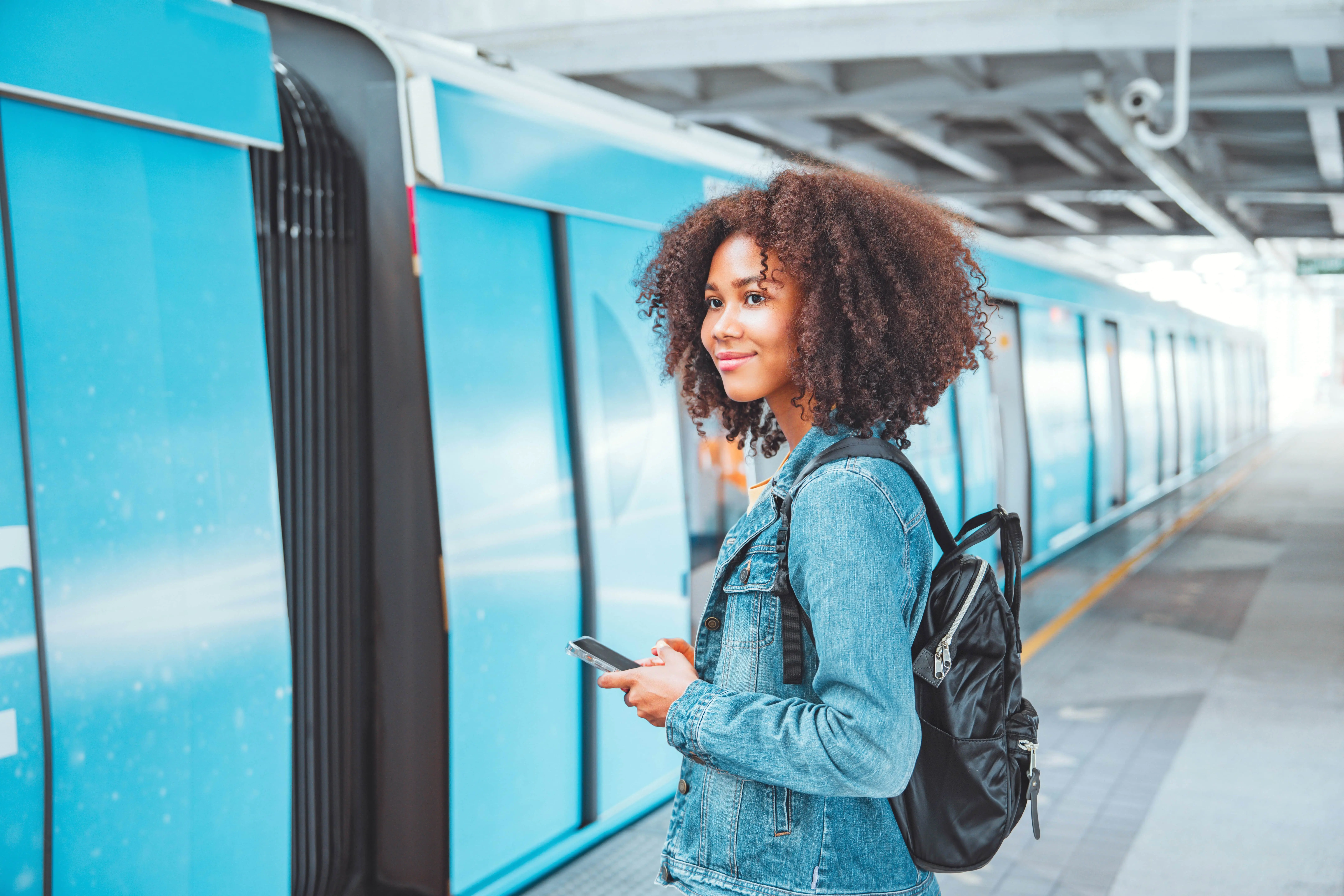 A young woman prepares to board a train.