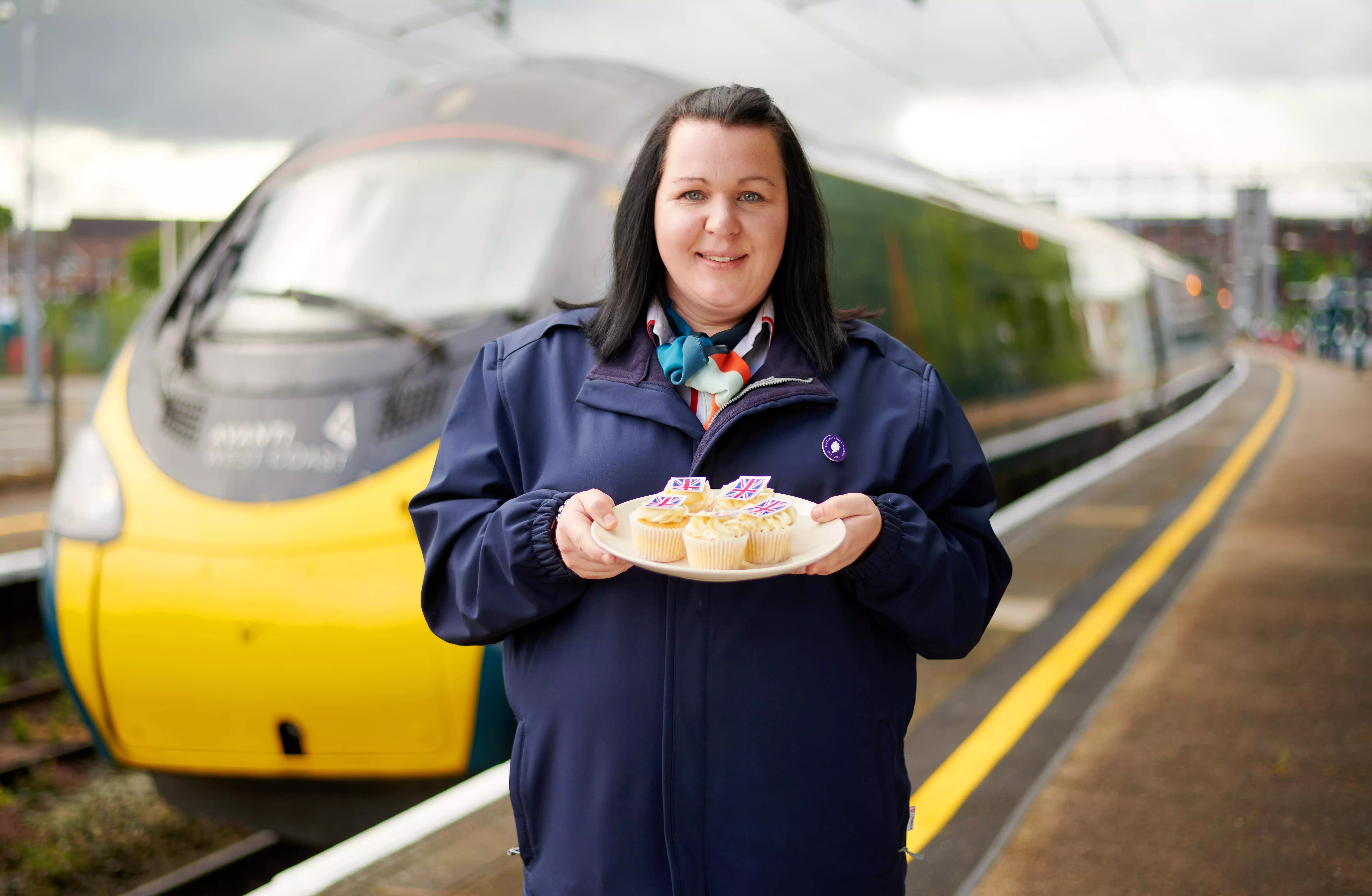 Laura Warwick with cakes for Queen's Jubilee at Runcorn station