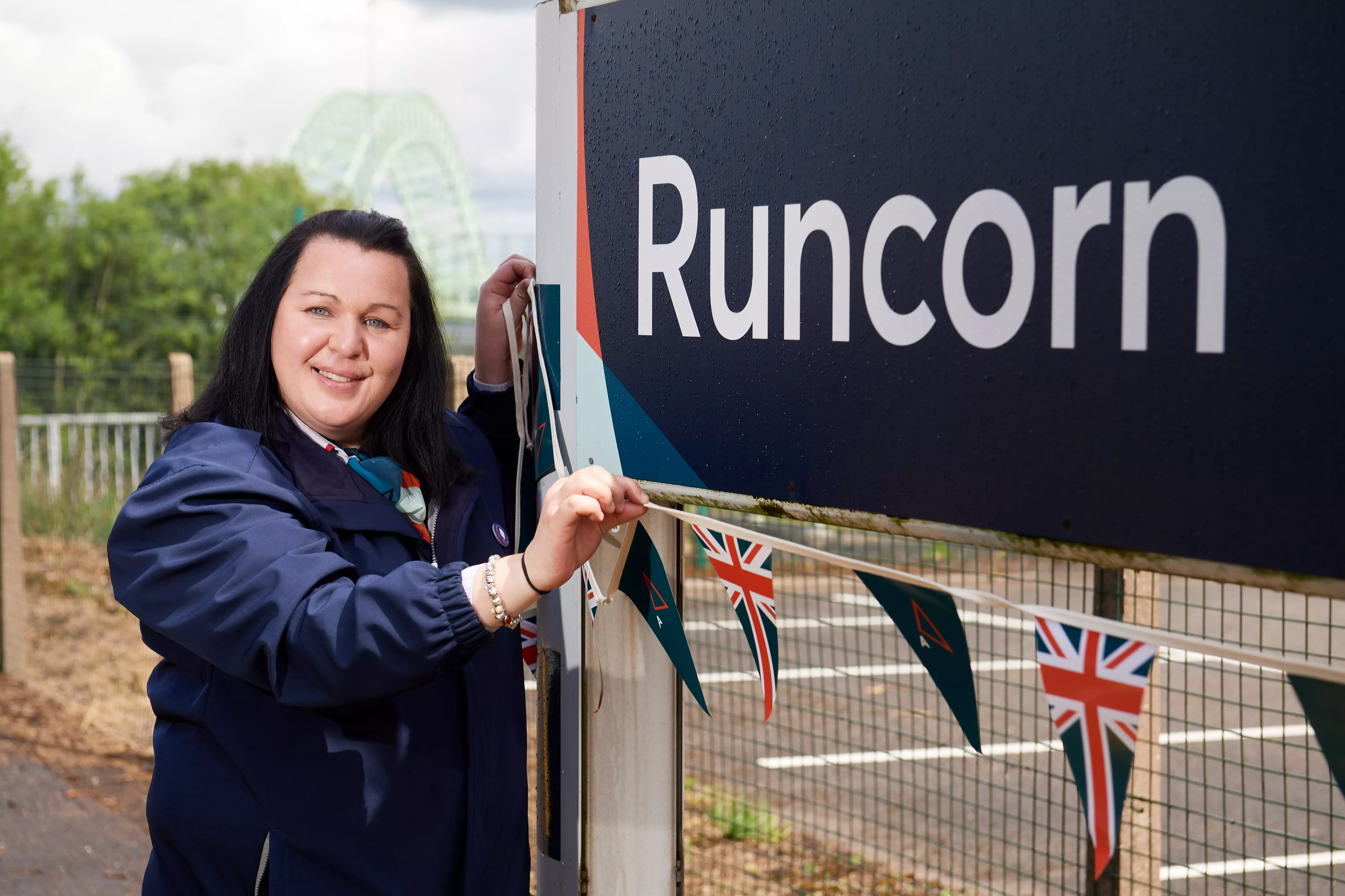 Laura Warwick at Runcorn station putting up flags for Queen's Jubilee